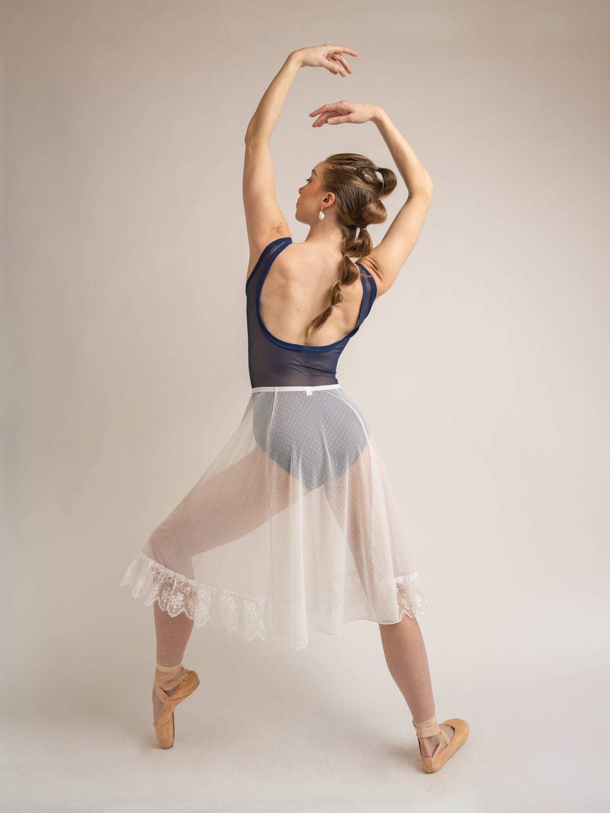 Dancer in tiered tulle, arms wide
