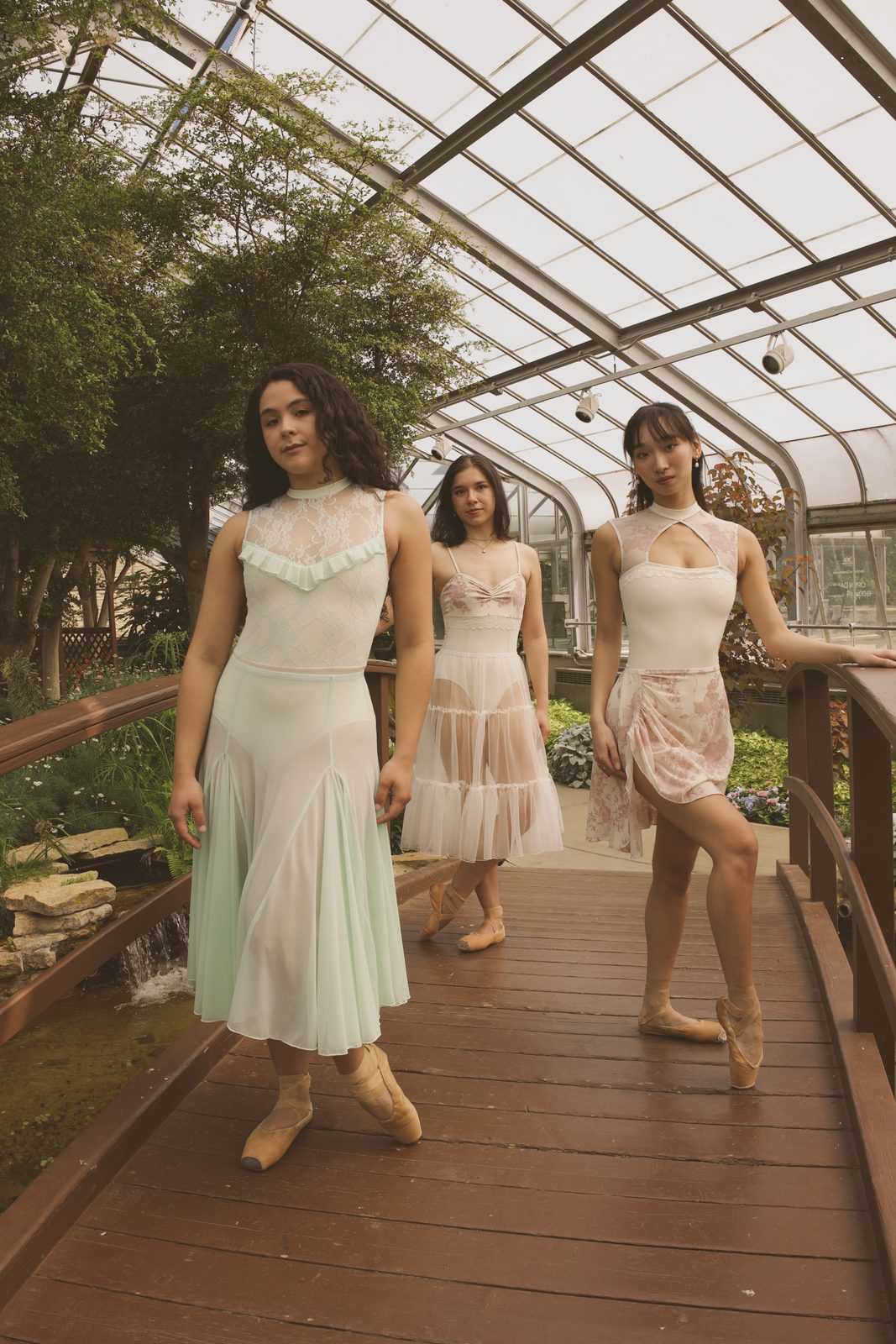 Dancers walking through a greenhouse