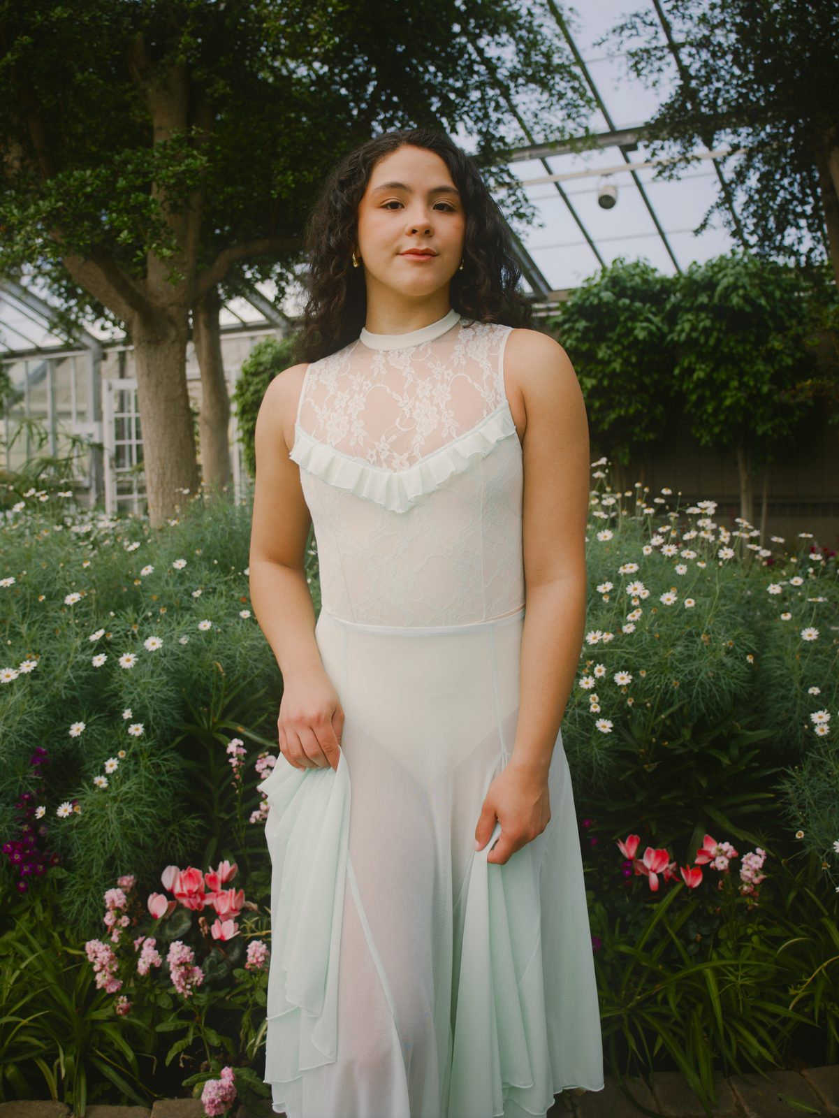 Dancer in a white lace dress among flowers
